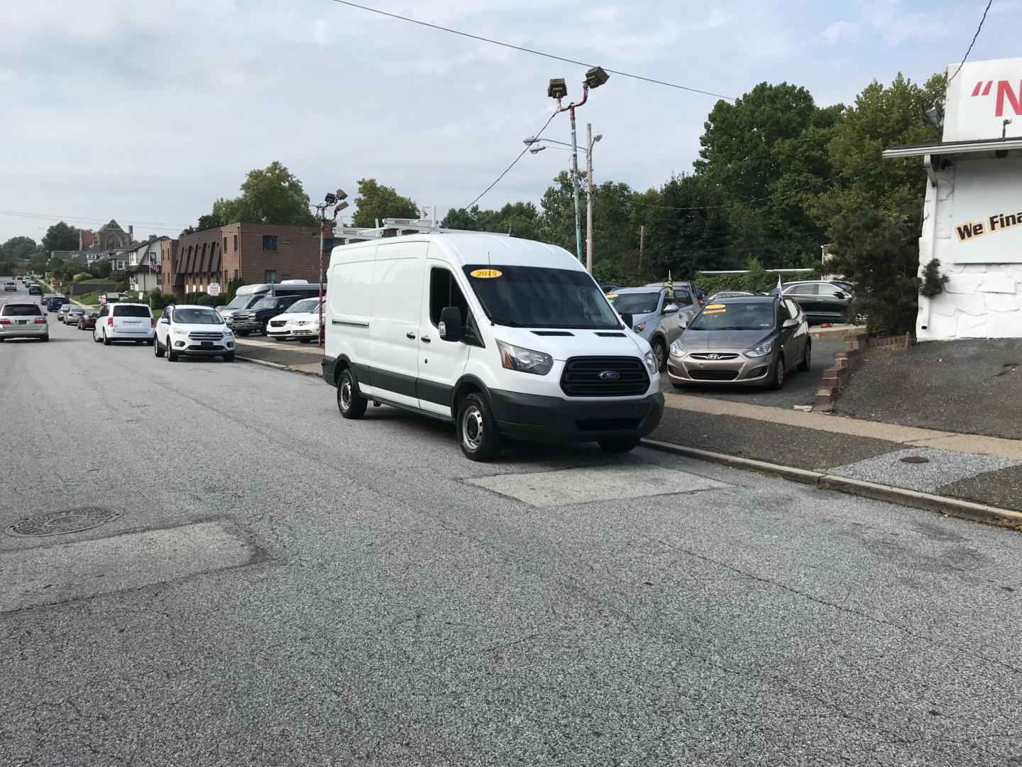 2015 White /Gray Ford Transit 150 Van Med. Roof 148-in. WB (1FTNE2CM7FK) with an 3.7L V6 DOHC 24V engine, 6-Speed Automatic transmission, located at 577 Chester Pike, Prospect Park, PA, 19076, (610) 237-1015, 39.886154, -75.302338 - 15 Ford Transit 150 Cargo Van: Medium Roof, ladder racks, bulkhead, new PA inspection, FLEET MAINTAINED! This vehicle comes inspected and has been given a bumper to bumper safety check. It is very clean, reliable, and well maintained. We offer a unique pay plan that is known for being the easiest - Photo#2