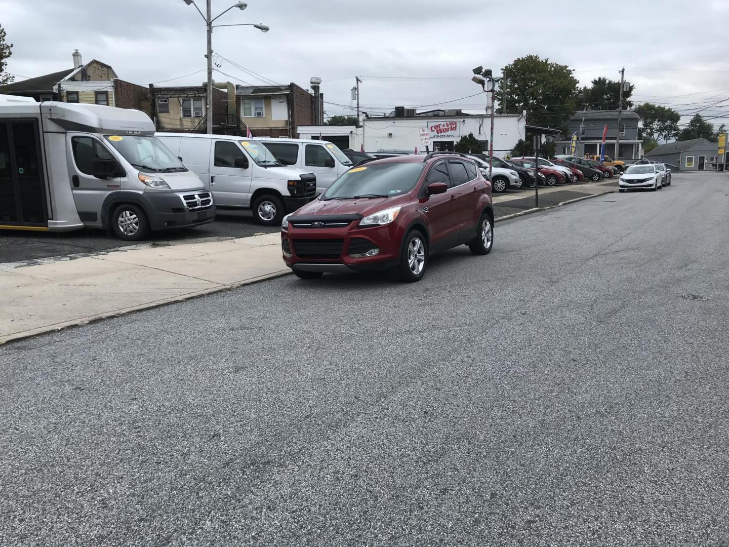 2016 Red /Gray Ford Escape SE 4WD (1FMCU9GX4GU) with an 1.6L L4 DOHC 16V engine, 6-Speed Automatic transmission, located at 577 Chester Pike, Prospect Park, PA, 19076, (610) 237-1015, 39.886154, -75.302338 - Photo#1