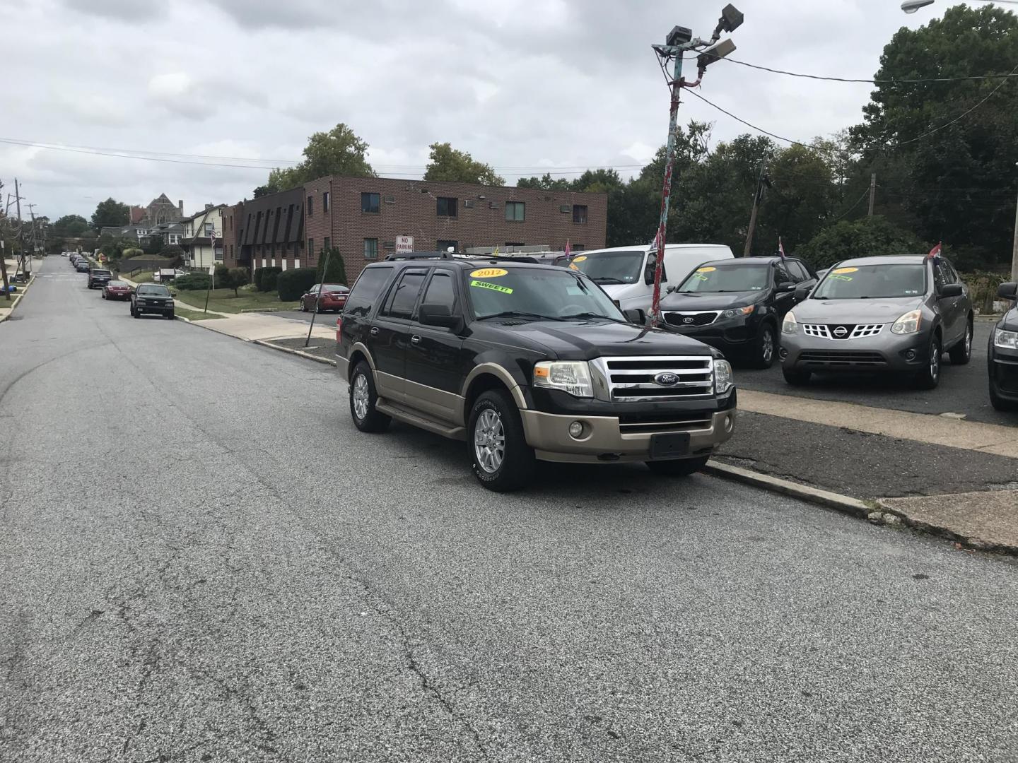 2012 Black /Tan Ford Expedition King Ranch 4WD (1FMJU1J56CE) with an 5.4L V8 SOHC 16V FFV engine, 6-Speed Automatic transmission, located at 577 Chester Pike, Prospect Park, PA, 19076, (610) 237-1015, 39.886154, -75.302338 - 2012 Ford Expedition XLT: DVD player w/ TV's in both headrests, 3rd row seating, 4x4, navigation system, backup camera, runs LIKE NEW! This vehicle comes inspected and has been given a bumper to bumper safety check. It is very clean, reliable, and well maintained. We offer a unique pay plan that - Photo#1