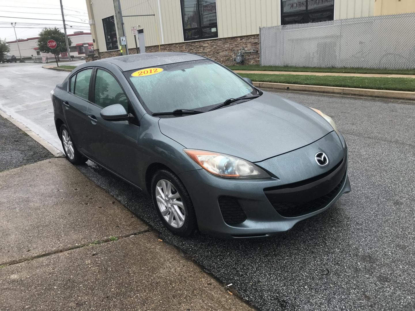 2012 Green /Gray Mazda MAZDA3 i Touring 4-Door (JM1BL1V87C1) with an 2.0L L4 DOHC 16V engine, Automatic transmission, located at 577 Chester Pike, Prospect Park, PA, 19076, (610) 237-1015, 39.886154, -75.302338 - 2012 Mazda 3 i Touring: Only 123k miles, great on gas, sunroof, new PA inspection, runs LIKE NEW! This vehicle comes inspected and has been given a bumper to bumper safety check. It is very clean, reliable, and well maintained. We offer a unique pay plan that is known for being the easiest and fa - Photo#2