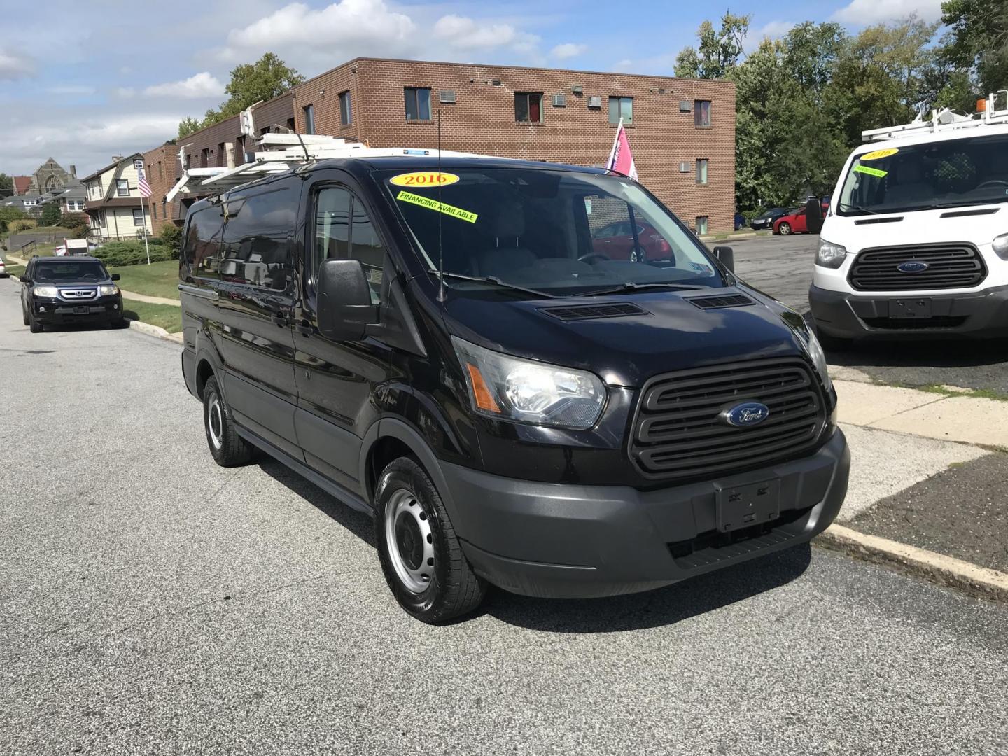 2016 Black /Gray Ford Transit 150 Van Low Roof w/Sliding Pass. 130-in. WB (1FTYE1YM4GK) with an 3.7L V6 DOHC 24V engine, 6A transmission, located at 577 Chester Pike, Prospect Park, PA, 19076, (610) 237-1015, 39.886154, -75.302338 - 2015 Ford Transit 150 Low Roof: Fully metal no windows, ladder racks, new PA inspection, SUPER CLEAN, runs LIKE NEW! This vehicle comes inspected and has been given a bumper to bumper safety check. It is very clean, reliable, and well maintained. We offer a unique pay plan that is known for being - Photo#1