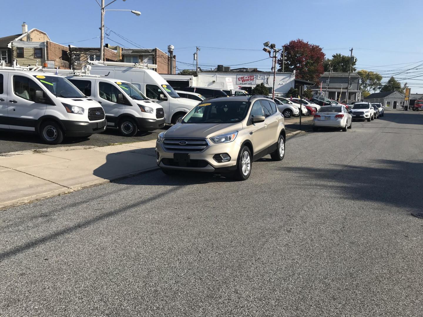 2018 Gold /Gray Ford Escape SE 4WD (1FMCU9GD5JU) with an 1.5L L4 DOHC 16V engine, 6A transmission, located at 577 Chester Pike, Prospect Park, PA, 19076, (610) 237-1015, 39.886154, -75.302338 - Photo#1