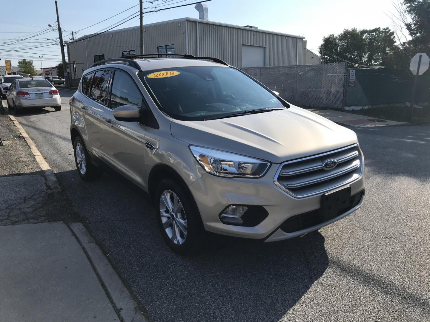 2018 Gold /Gray Ford Escape SE 4WD (1FMCU9GD5JU) with an 1.5L L4 DOHC 16V engine, 6A transmission, located at 577 Chester Pike, Prospect Park, PA, 19076, (610) 237-1015, 39.886154, -75.302338 - 2018 Ford Escape SE: 4x4, new PA inspection, backup camera, great on gas, runs LIKE NEW! This vehicle comes inspected and has been given a bumper to bumper safety check. It is very clean, reliable, and well maintained. We offer a unique pay plan that is known for being the easiest and fastest fin - Photo#2