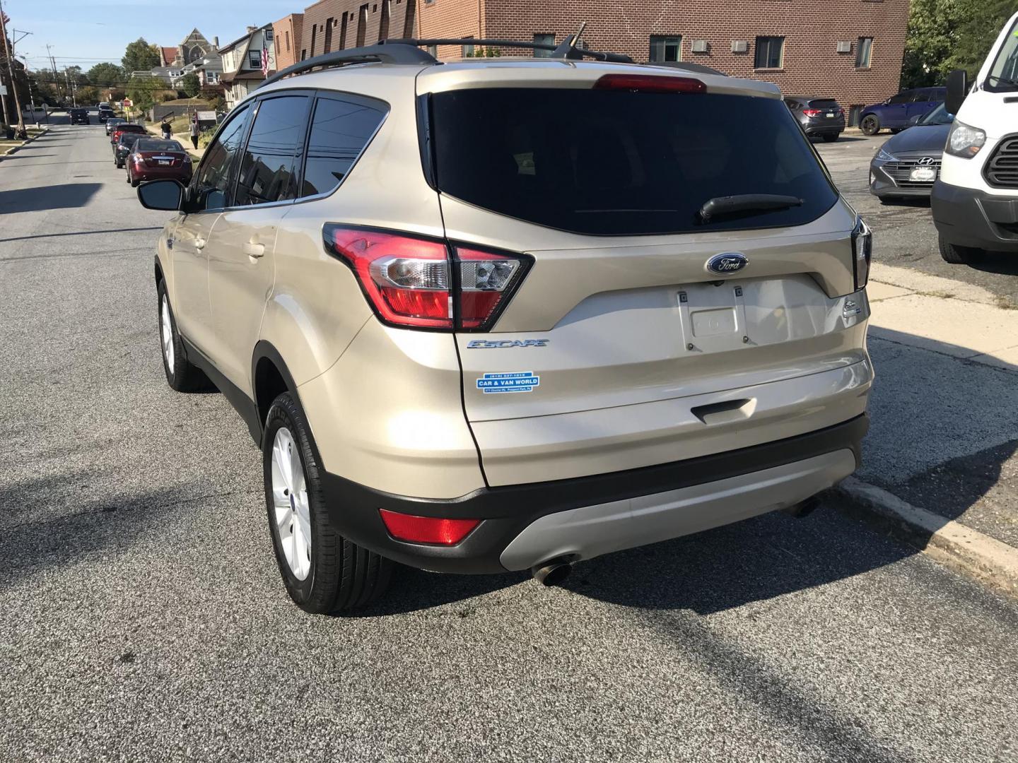 2018 Gold /Gray Ford Escape SE 4WD (1FMCU9GD5JU) with an 1.5L L4 DOHC 16V engine, 6A transmission, located at 577 Chester Pike, Prospect Park, PA, 19076, (610) 237-1015, 39.886154, -75.302338 - Photo#4