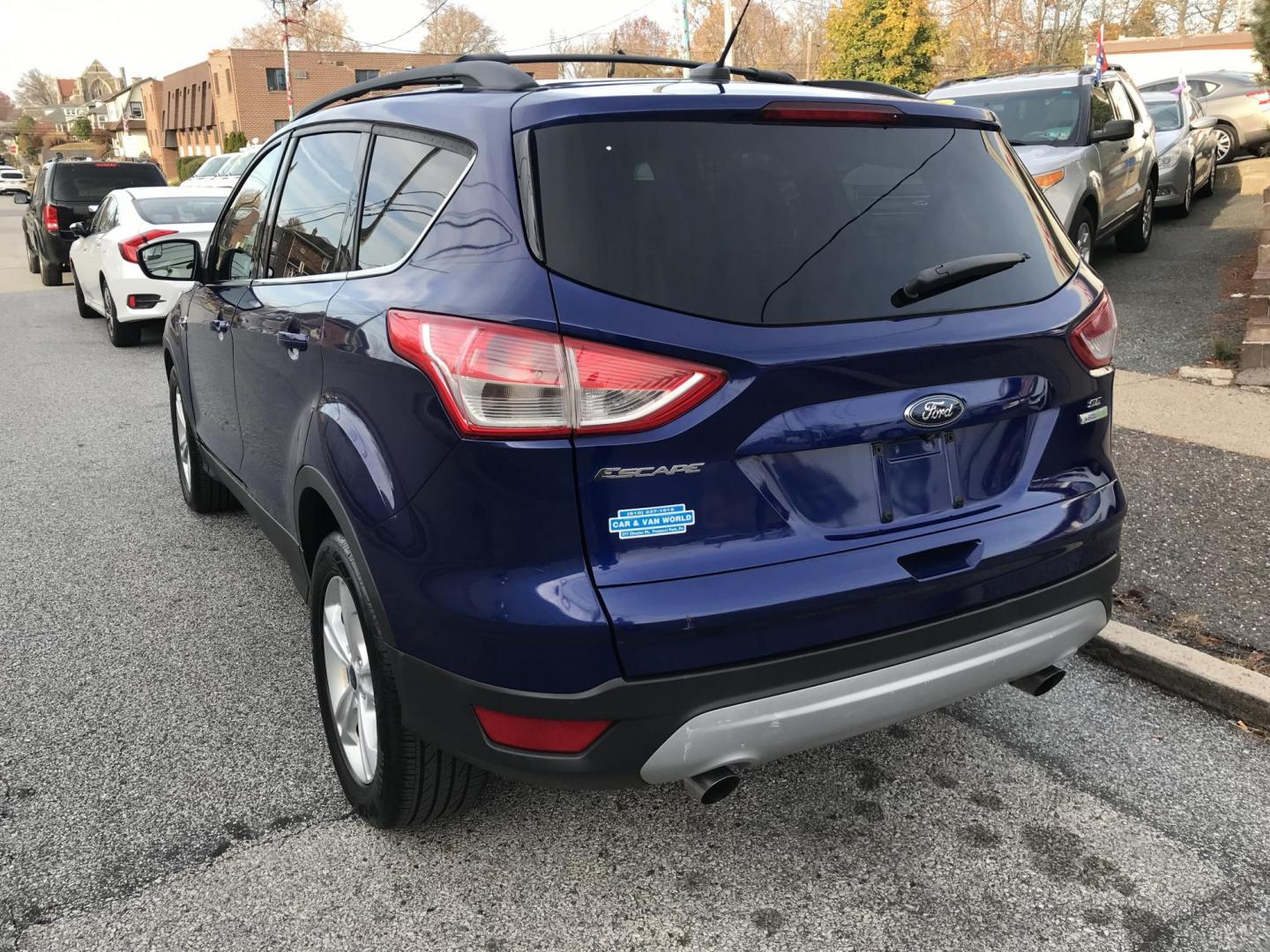 2014 Blue /Gray Ford Escape SE (1FMCU0GX7EU) with an 1.6L L4 DOHC 16V engine, 6-Speed Automatic transmission, located at 577 Chester Pike, Prospect Park, PA, 19076, (610) 237-1015, 39.886154, -75.302338 - 2014 Ford Escape SE: Only 93k miles, backup camera, new PA inspection, great on gas, looks and runs LIKE NEW! This vehicle comes inspected and has been given a bumper to bumper safety check. It is very clean, reliable, and well maintained. We offer a unique pay plan that is known for being the ea - Photo#5