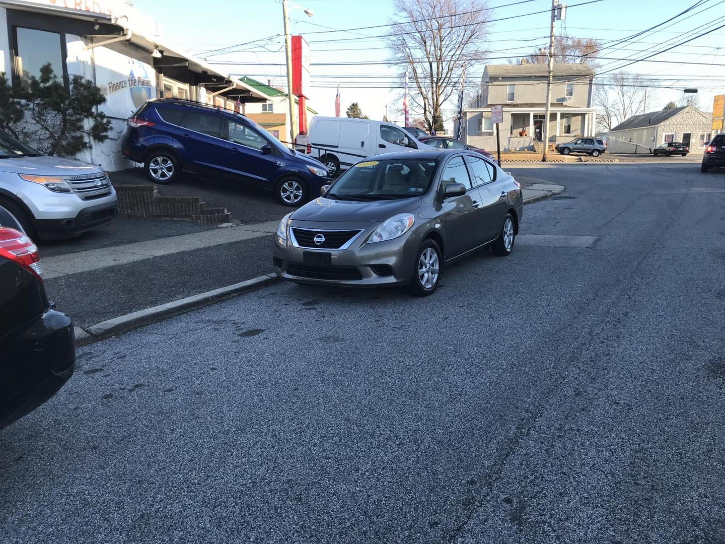 2014 Gray /Gray Nissan Versa 1.6 SV (3N1CN7AP4EL) with an 1.6L L4 DOHC 16V engine, Automatic transmission, located at 577 Chester Pike, Prospect Park, PA, 19076, (610) 237-1015, 39.886154, -75.302338 - Photo#1