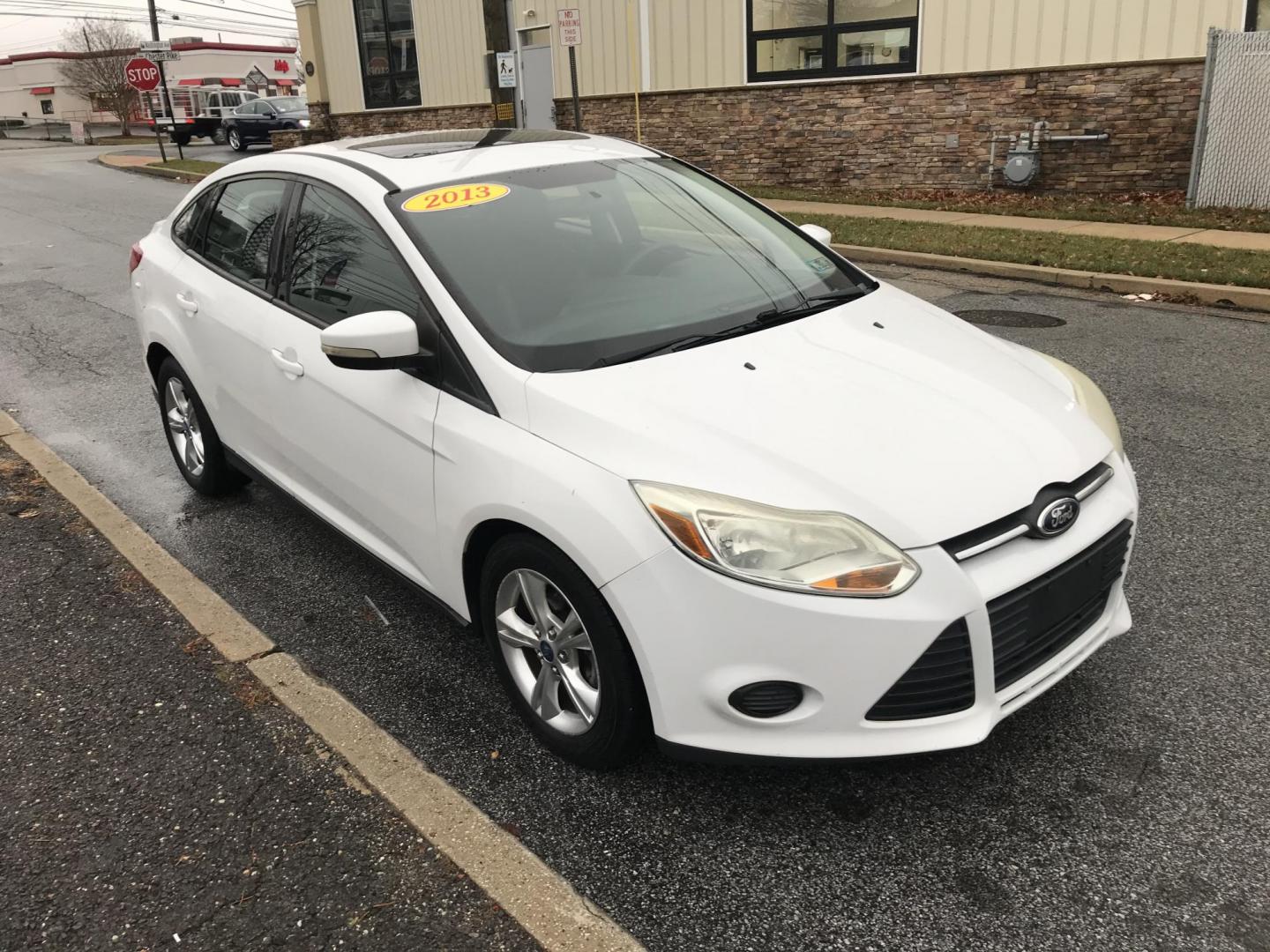 2013 White /Black Ford Focus SE Sedan (1FADP3F20DL) with an 2.0L L4 DOHC 16V engine, Automatic transmission, located at 577 Chester Pike, Prospect Park, PA, 19076, (610) 237-1015, 39.886154, -75.302338 - 2013 Ford Focus SE: Only 95k miles, sunroof, great on gas, new PA inspection, runs LIKE NEW! This vehicle comes inspected and has been given a bumper to bumper safety check. It is very clean, reliable, and well maintained. We offer a unique pay plan that is known for being the easiest and fastest - Photo#3